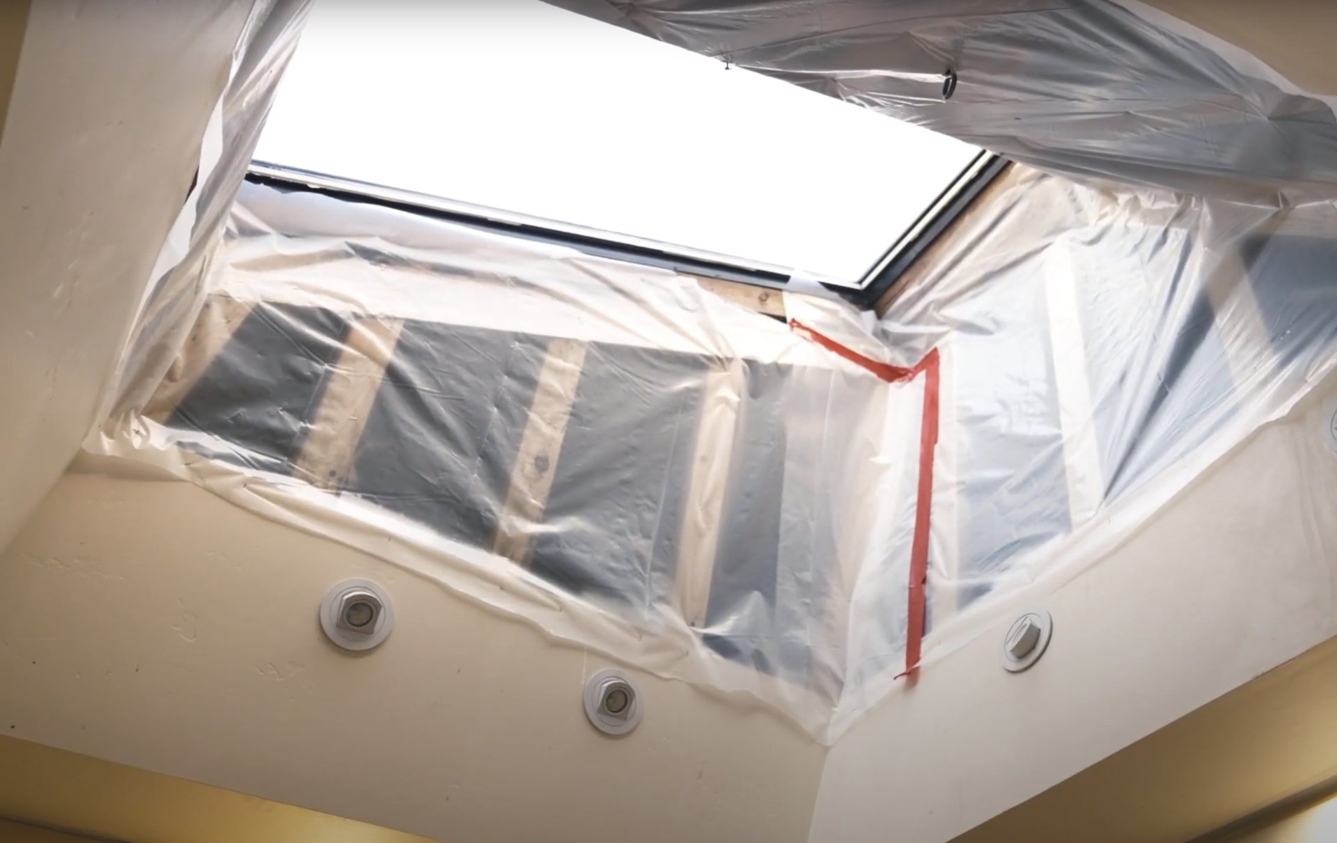 Professional plastic sheeting and containment setup for water damage restoration in Charleston home