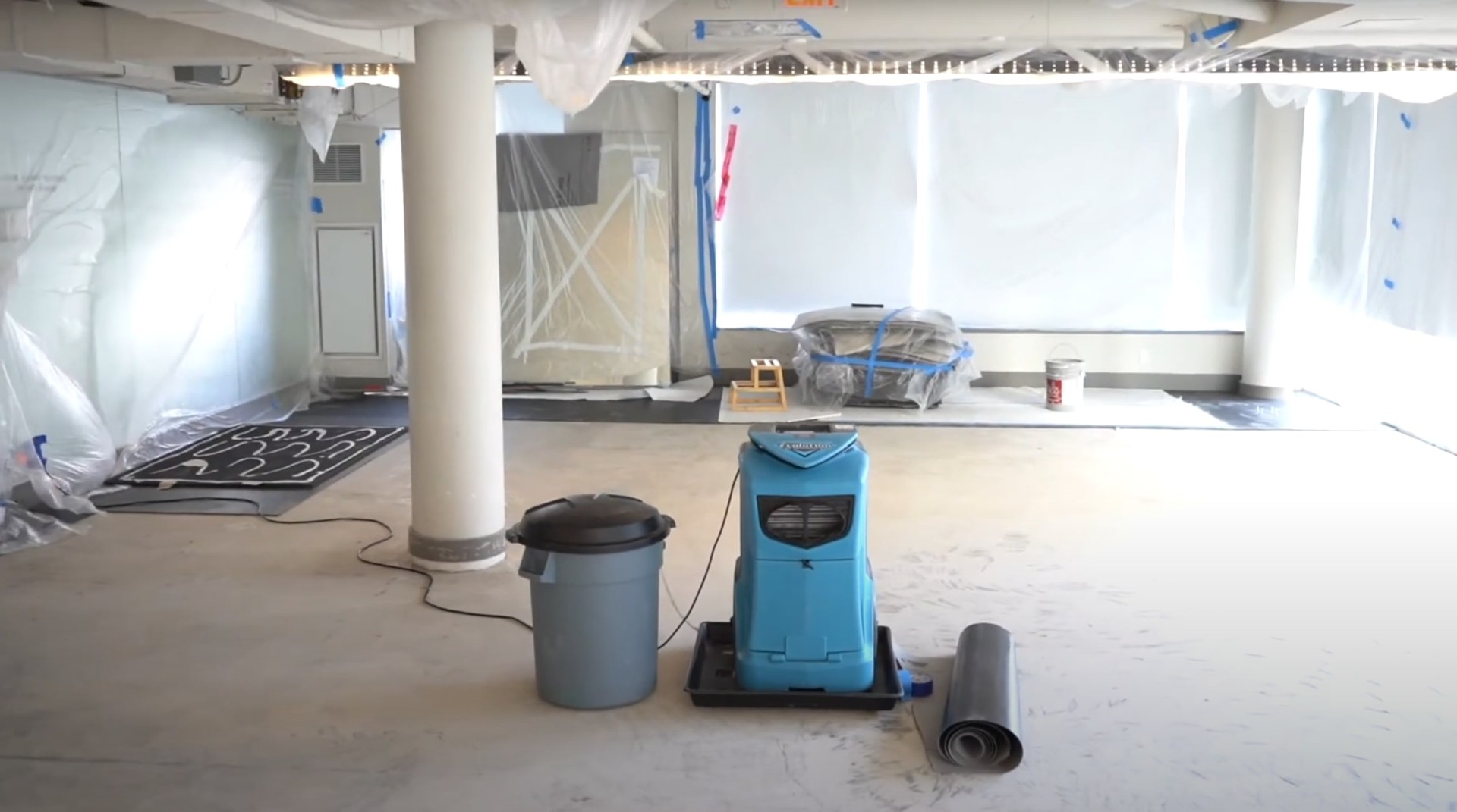 Water damage restoration equipment including dehumidifiers and air movers set up in Charleston office space